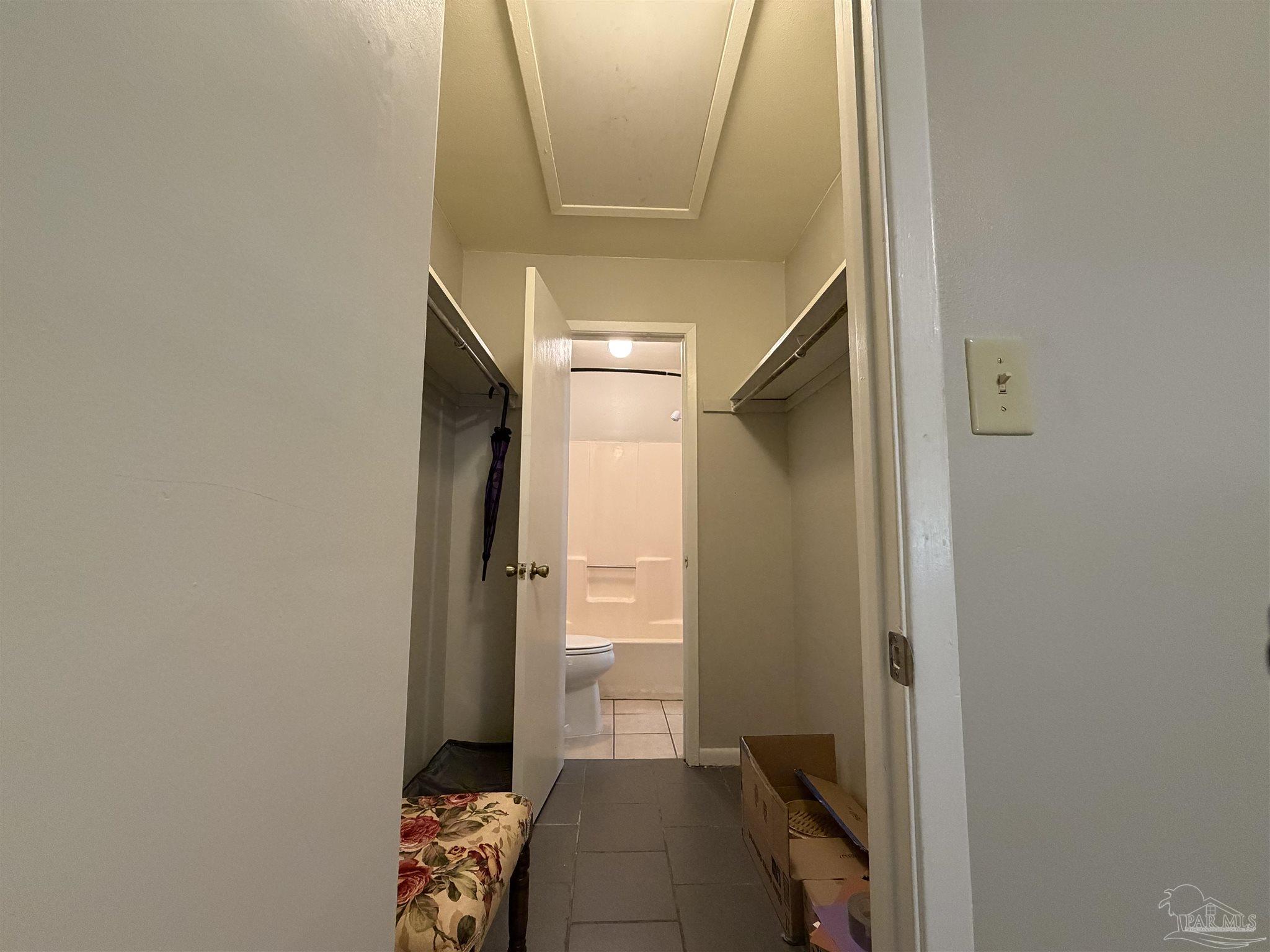 130 East 9 Mile Road, Unit 7 Pensacola, FL 32534 - Photo 27 of 61 a hallway with sliding door and wooden floor