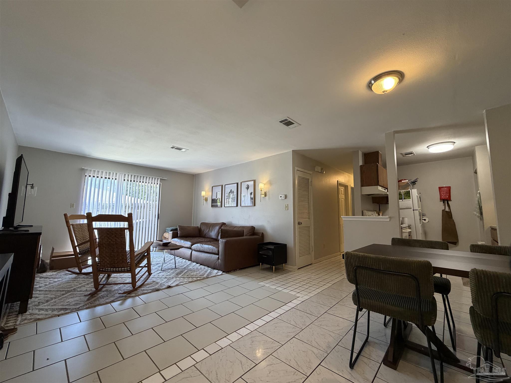 130 East 9 Mile Road, Unit 7 Pensacola, FL 32534 - Photo 30 of 61 a living room with furniture and a wooden floor