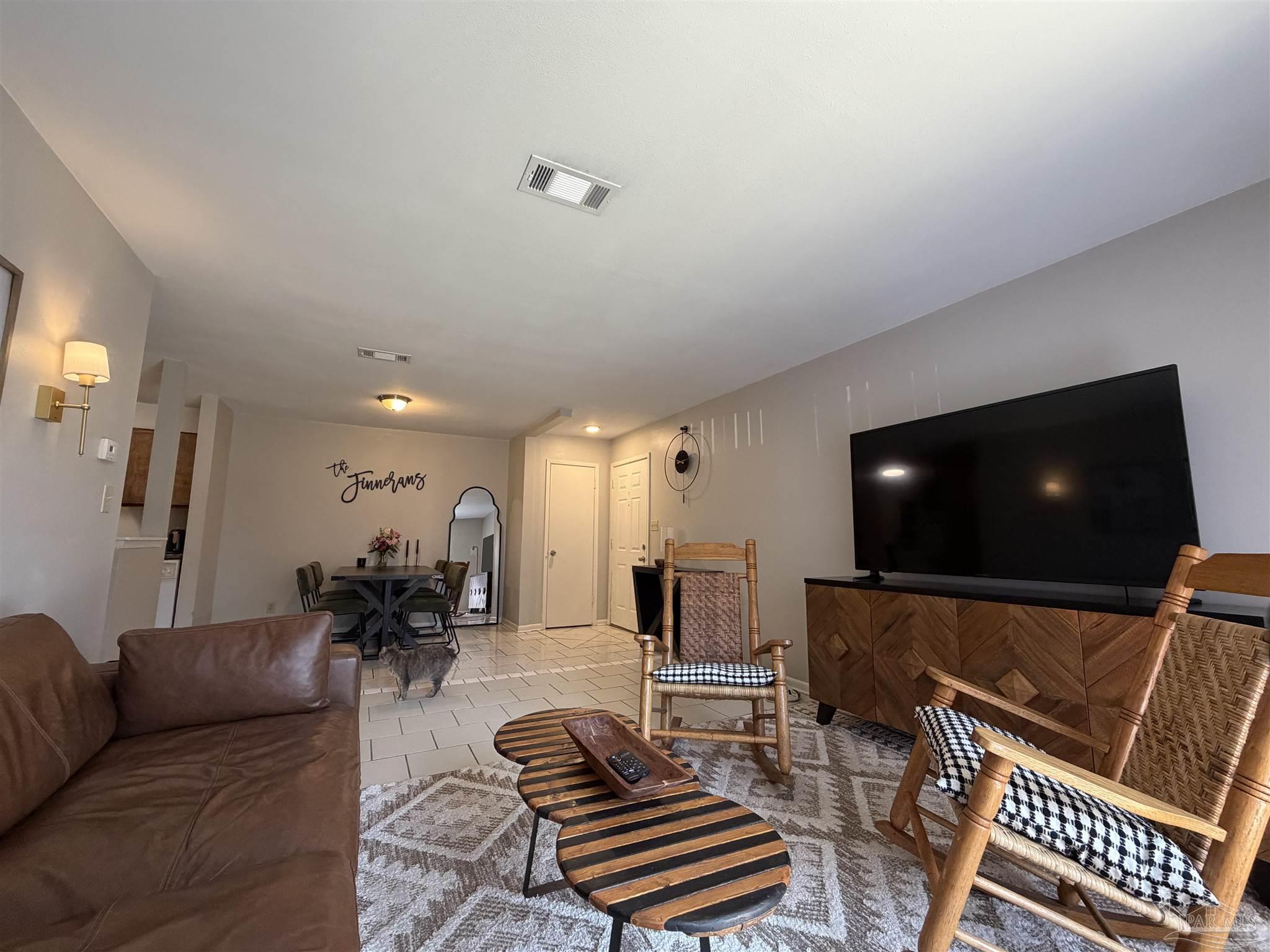 130 East 9 Mile Road, Unit 7 Pensacola, FL 32534 - Photo 31 of 61 a living room with furniture and a flat screen tv
