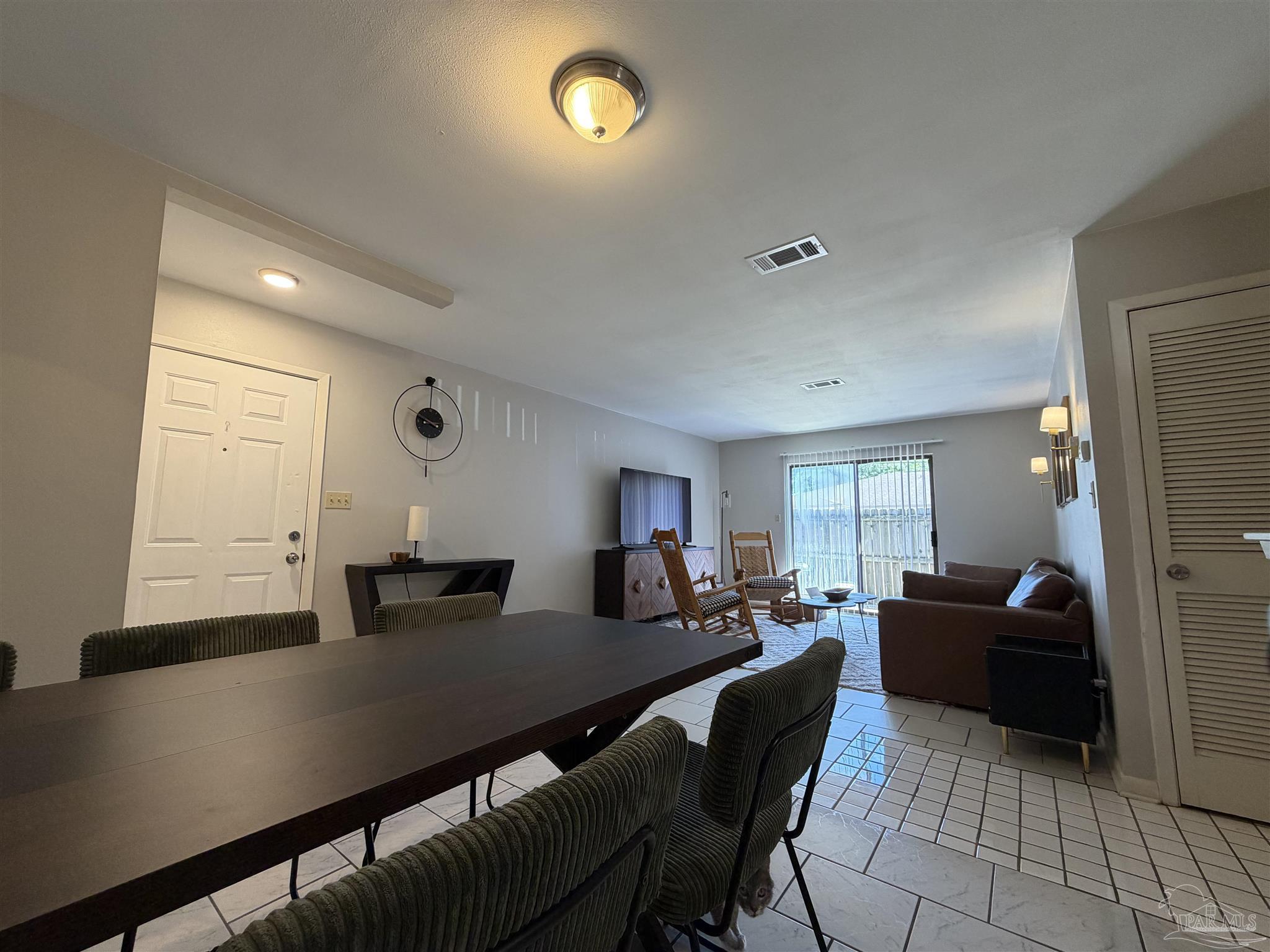 130 East 9 Mile Road, Unit 7 Pensacola, FL 32534 - Photo 32 of 61 a living room with furniture a window and a dining table