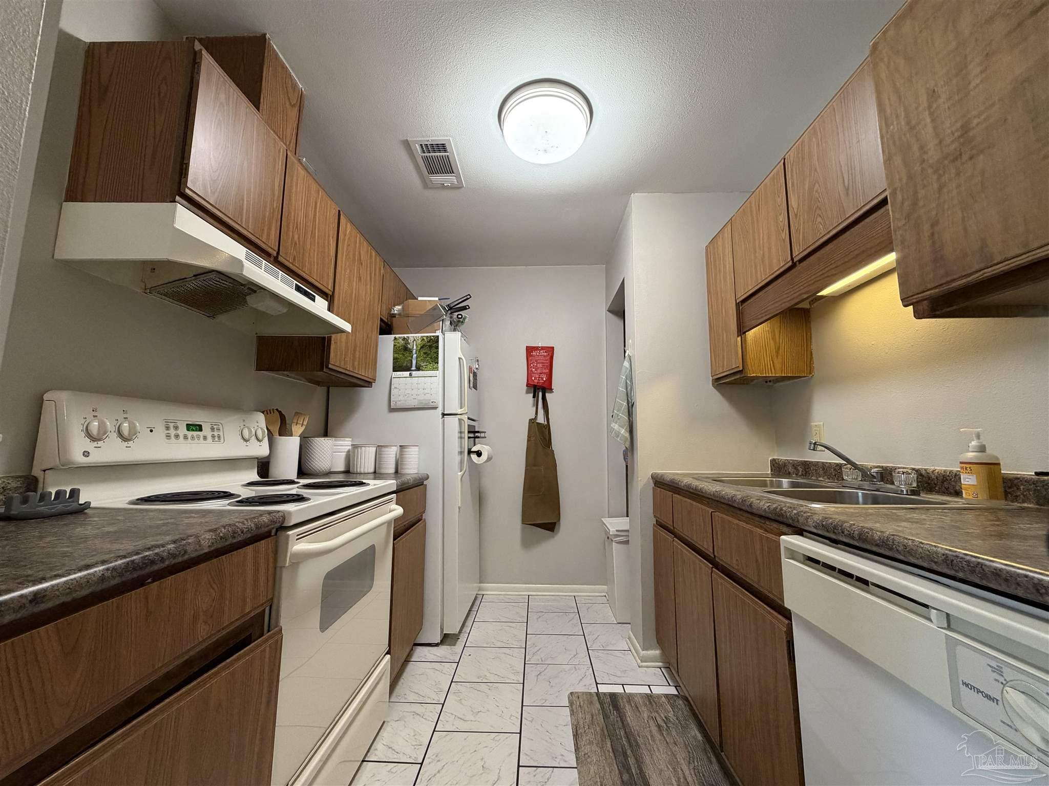 130 East 9 Mile Road, Unit 7 Pensacola, FL 32534 - Photo 33 of 61 a kitchen with stainless steel appliances granite countertop a sink and cabinets