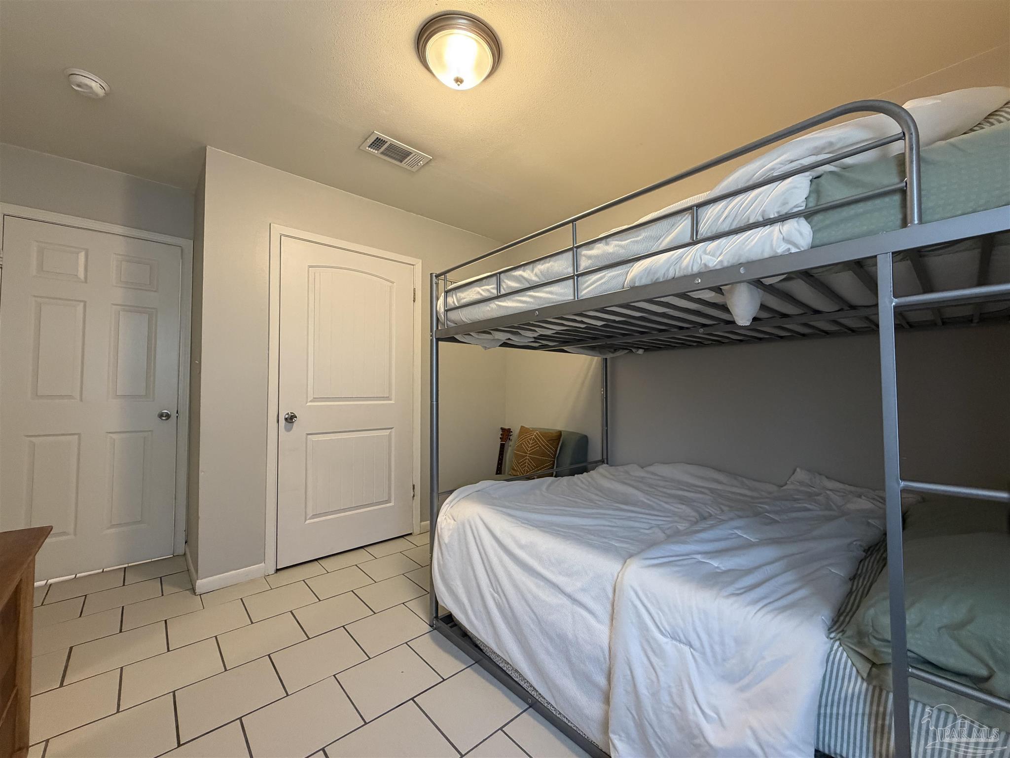 130 East 9 Mile Road, Unit 7 Pensacola, FL 32534 - Photo 37 of 61 a bedroom with a bed and a walk in closet