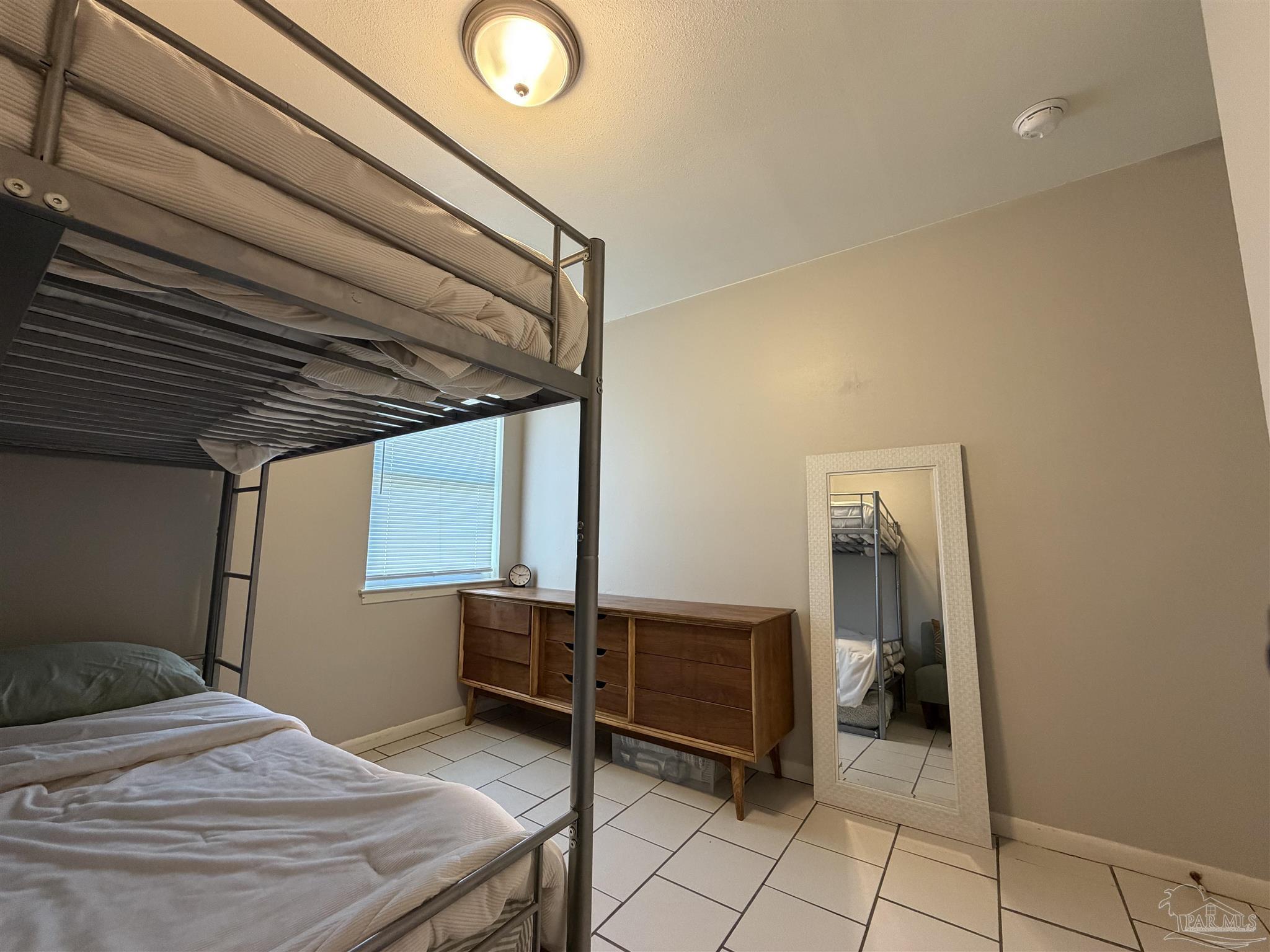 130 East 9 Mile Road, Unit 7 Pensacola, FL 32534 - Photo 38 of 61 a bedroom with a bed and a desk