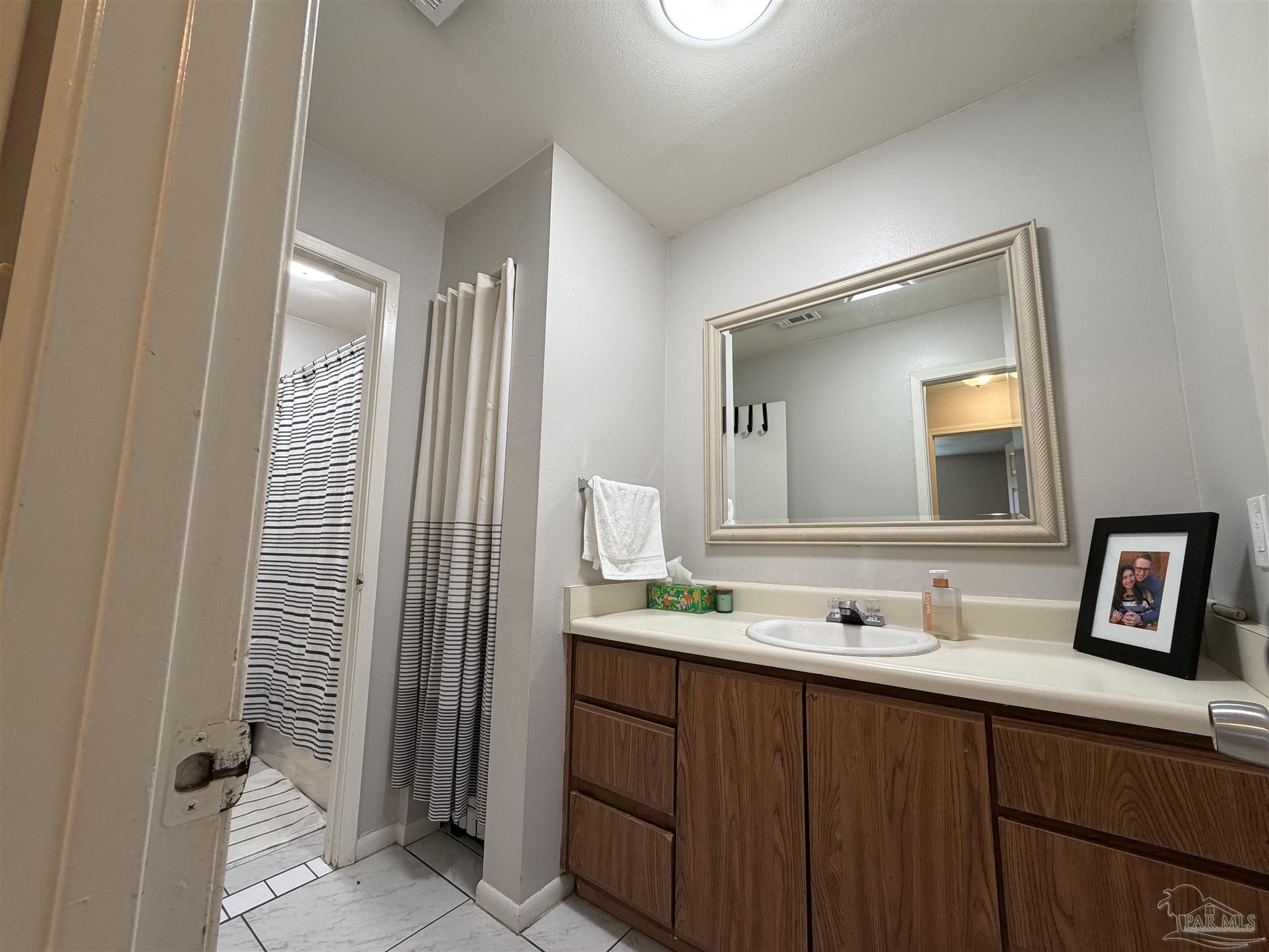 130 East 9 Mile Road, Unit 7 Pensacola, FL 32534 - Photo 42 of 61 a bathroom with a sink and a mirror