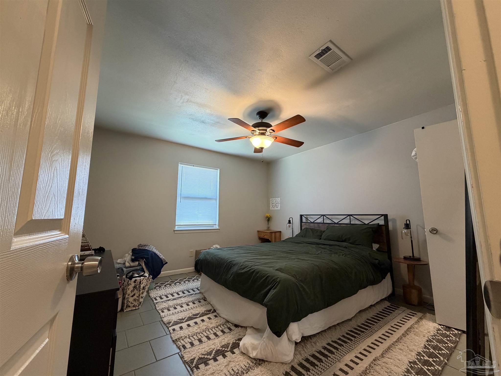 130 East 9 Mile Road, Unit 7 Pensacola, FL 32534 - Photo 44 of 61 a bedroom with a bed and a chandelier