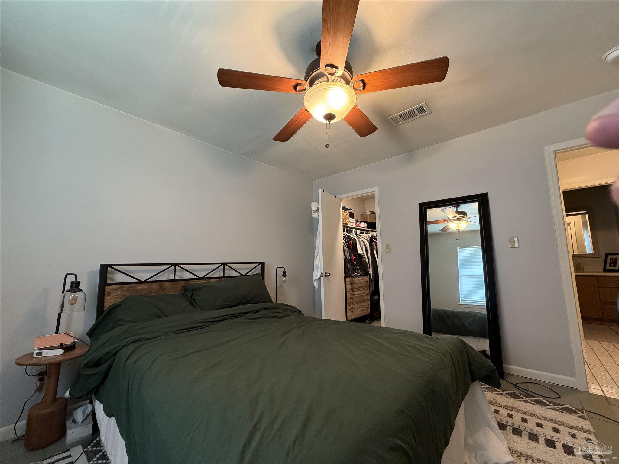 130 East 9 Mile Road, Unit 7 Pensacola, FL 32534 - Photo 45 of 61 a bedroom with a bed and a chandelier