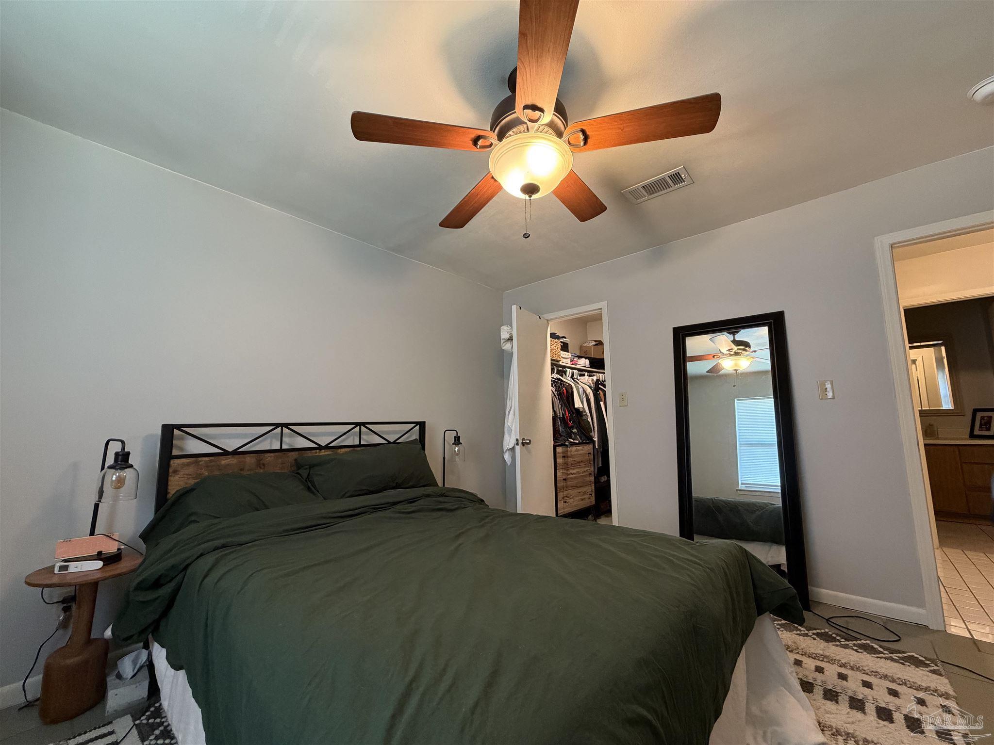 130 East 9 Mile Road, Unit 7 Pensacola, FL 32534 - Photo 46 of 61 a bedroom with a bed and a chandelier