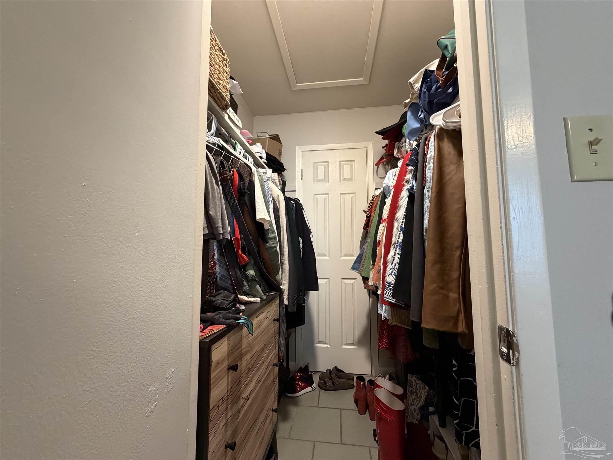 130 East 9 Mile Road, Unit 7 Pensacola, FL 32534 - Photo 48 of 61 a view of walk in closet with clothes and shoes