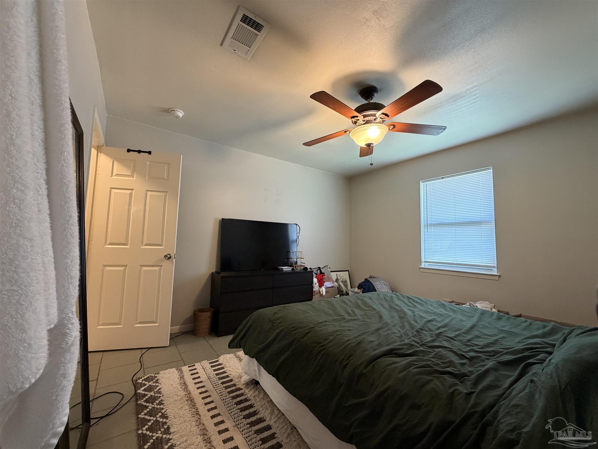 130 East 9 Mile Road, Unit 7 Pensacola, FL 32534 - Photo 49 of 61 a bed sitting in a bedroom next to a window