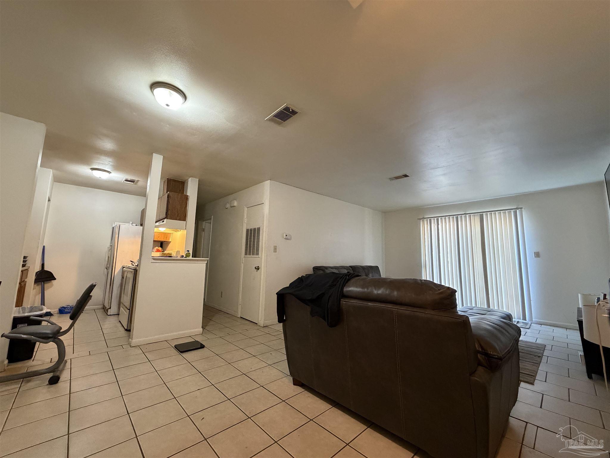 130 East 9 Mile Road, Unit 7 Pensacola, FL 32534 - Photo 51 of 61 a living room with furniture and a window