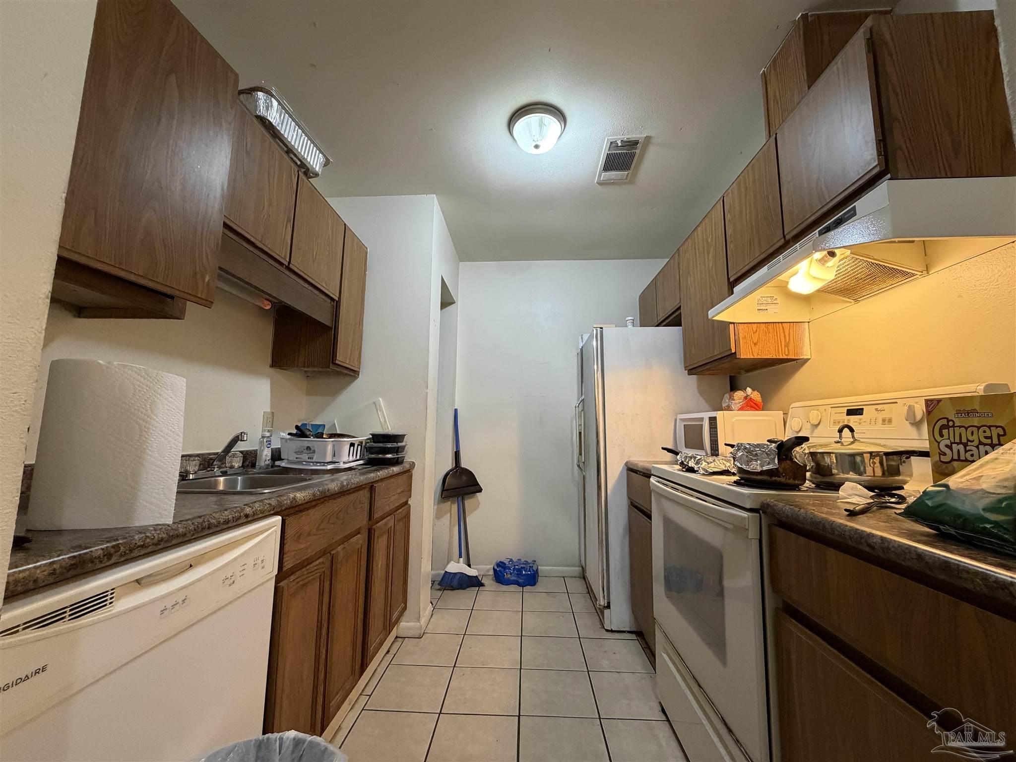 130 East 9 Mile Road, Unit 7 Pensacola, FL 32534 - Photo 53 of 61 a kitchen with a sink cabinets and stainless steel appliances