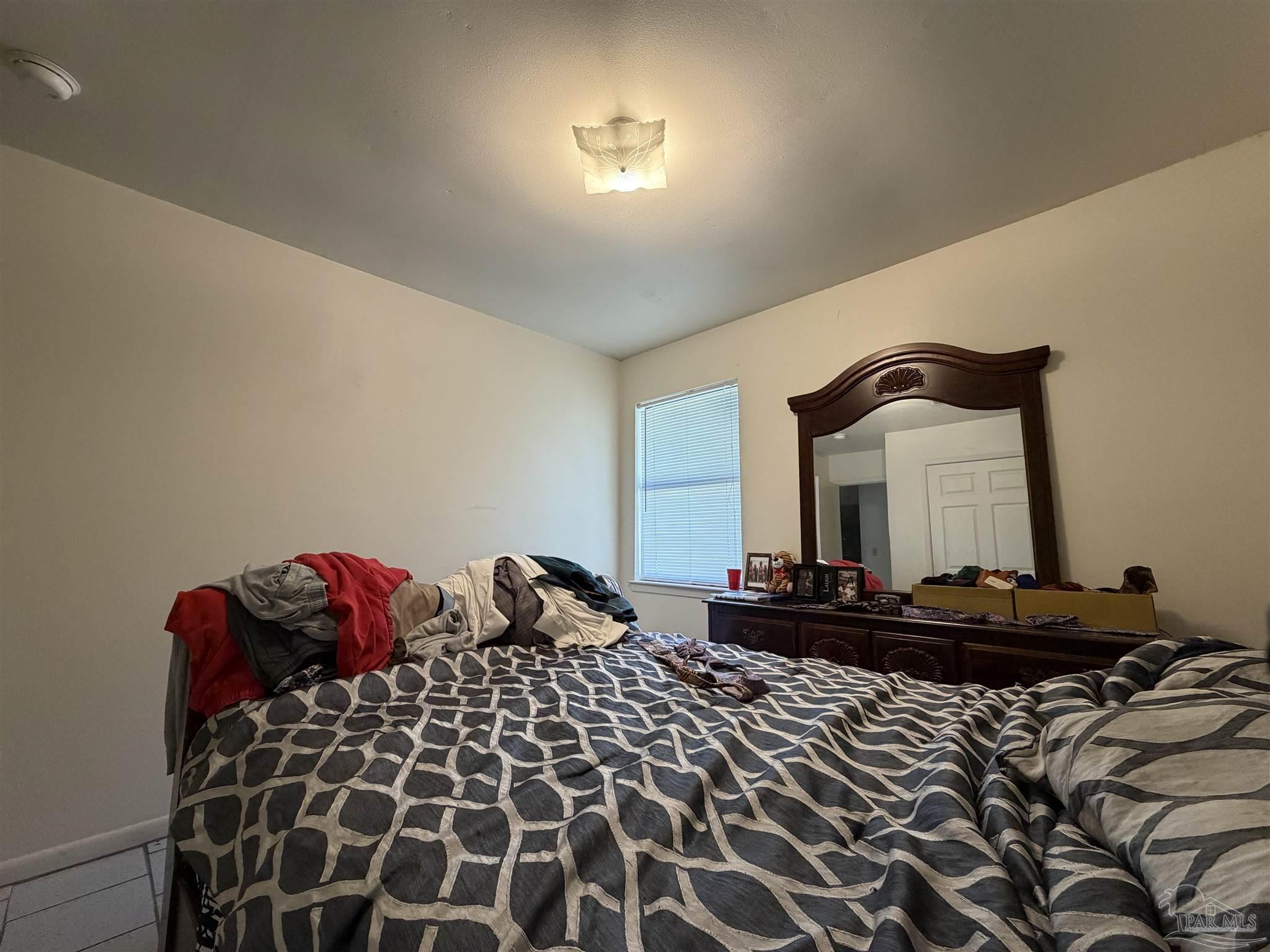 130 East 9 Mile Road, Unit 7 Pensacola, FL 32534 - Photo 56 of 61 a bedroom with bed and a mirror