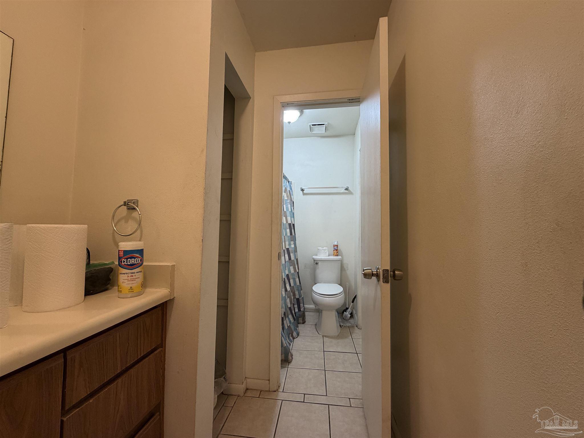 130 East 9 Mile Road, Unit 7 Pensacola, FL 32534 - Photo 57 of 61 a bathroom with a granite countertop sink and a toilet