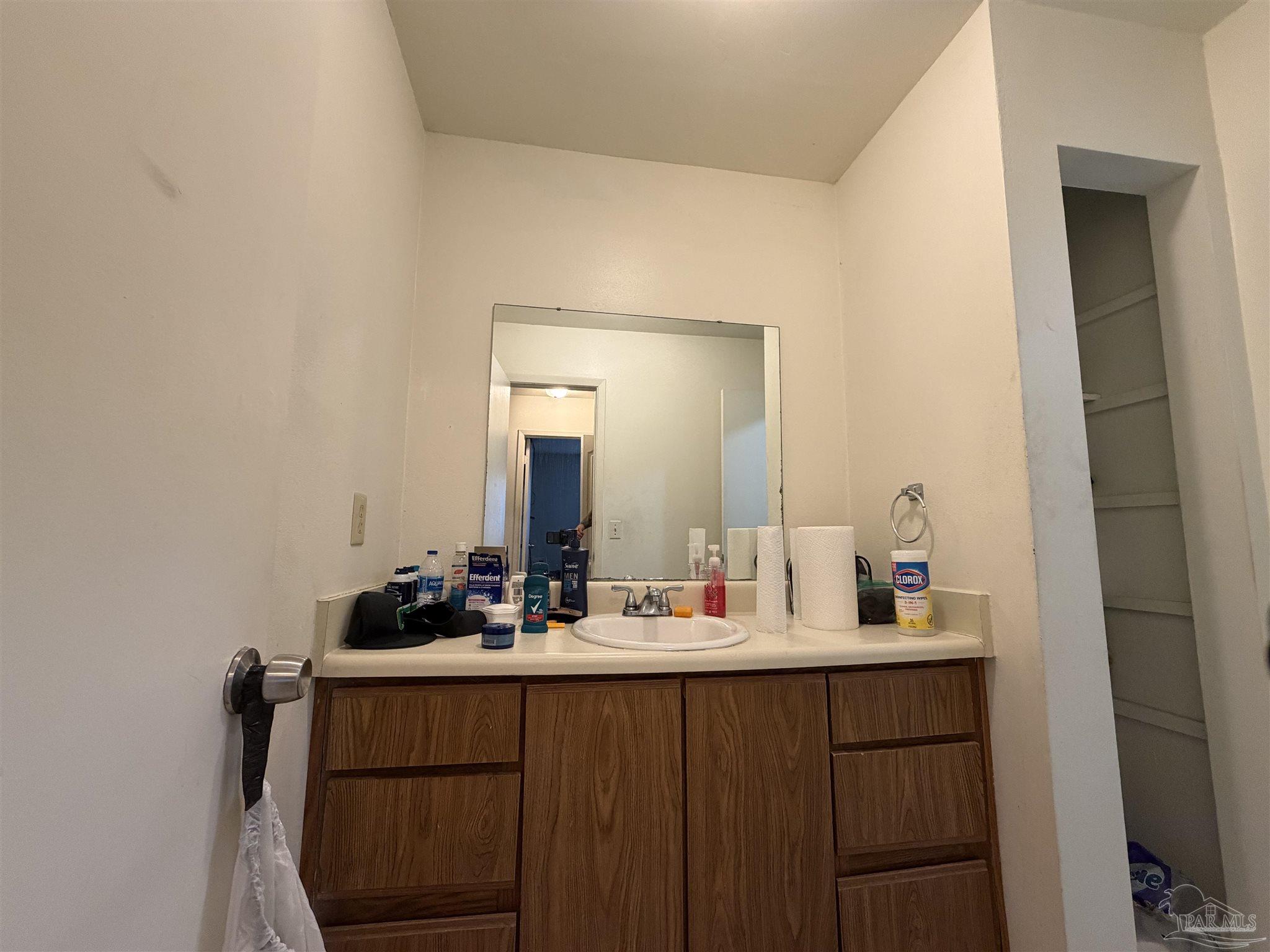 130 East 9 Mile Road, Unit 7 Pensacola, FL 32534 - Photo 58 of 61 a bathroom with a sink and a mirror