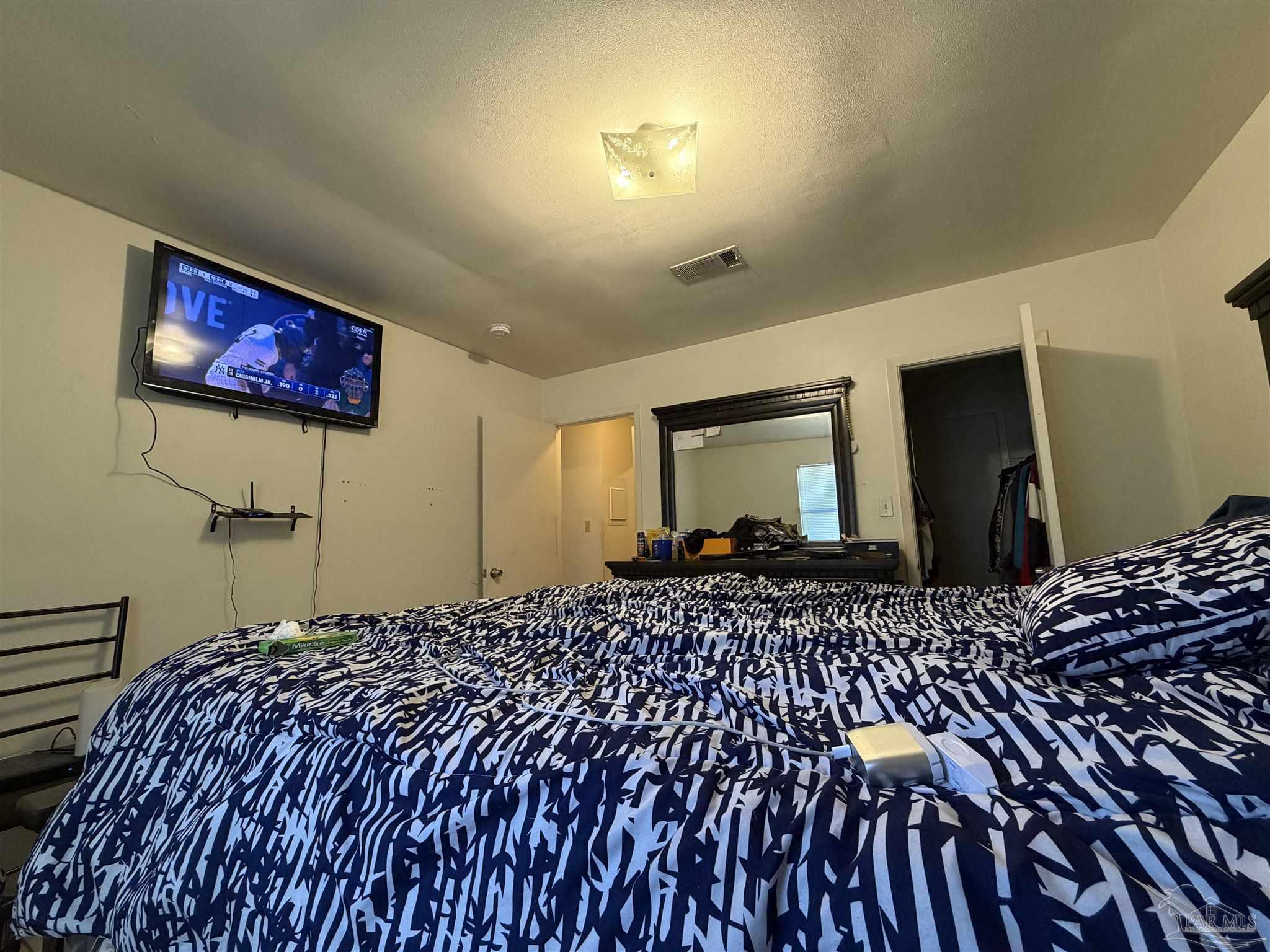 130 East 9 Mile Road, Unit 7 Pensacola, FL 32534 - Photo 60 of 61 a bedroom with bed and wooden floor