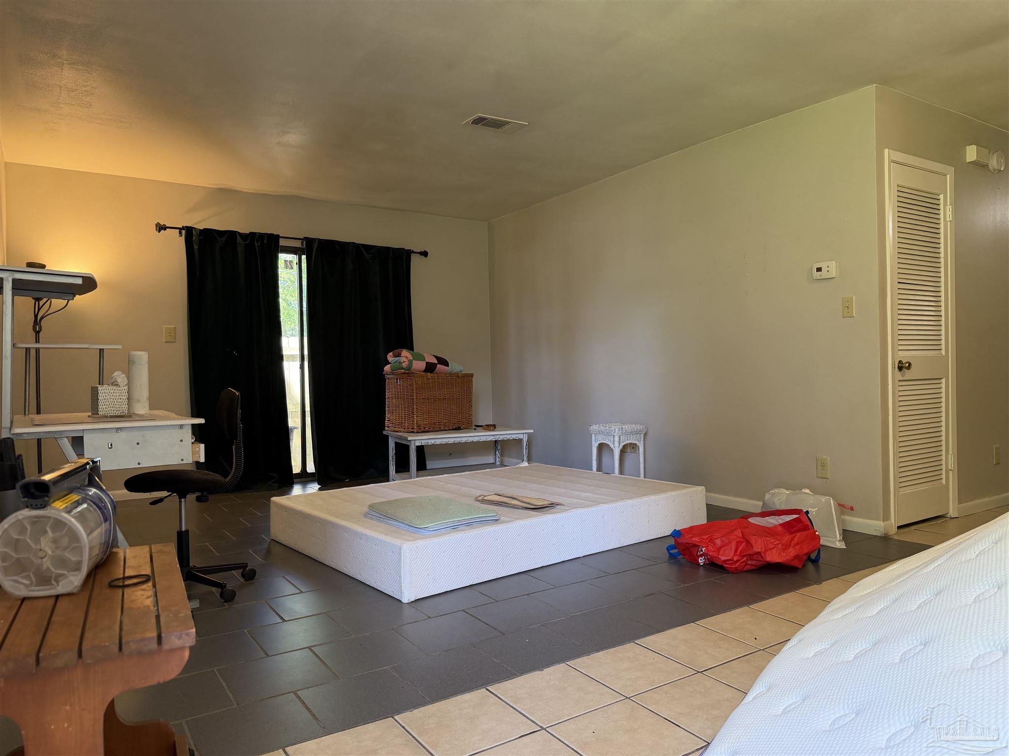 130 East 9 Mile Road, Unit 7 Pensacola, FL 32534 - Photo 6 of 61 a room with a bed and a table