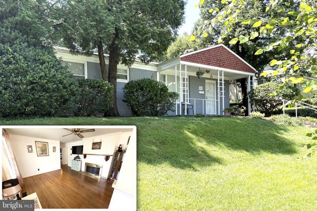 a front view of house with yard and trees