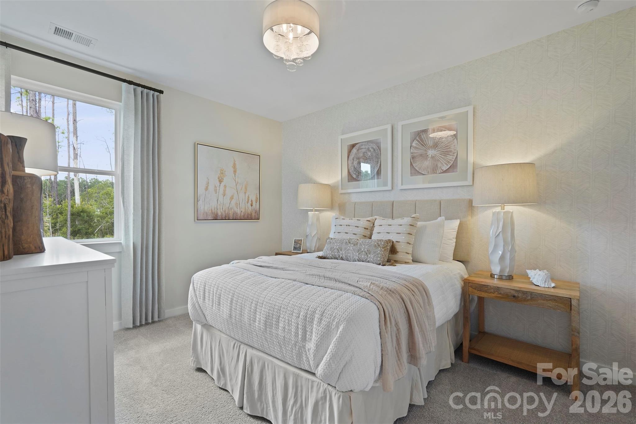 1099 Arundle Road Sherrills Ford, NC 28673 - Photo 15 of 40 a bedroom with a bed flowerpot and window