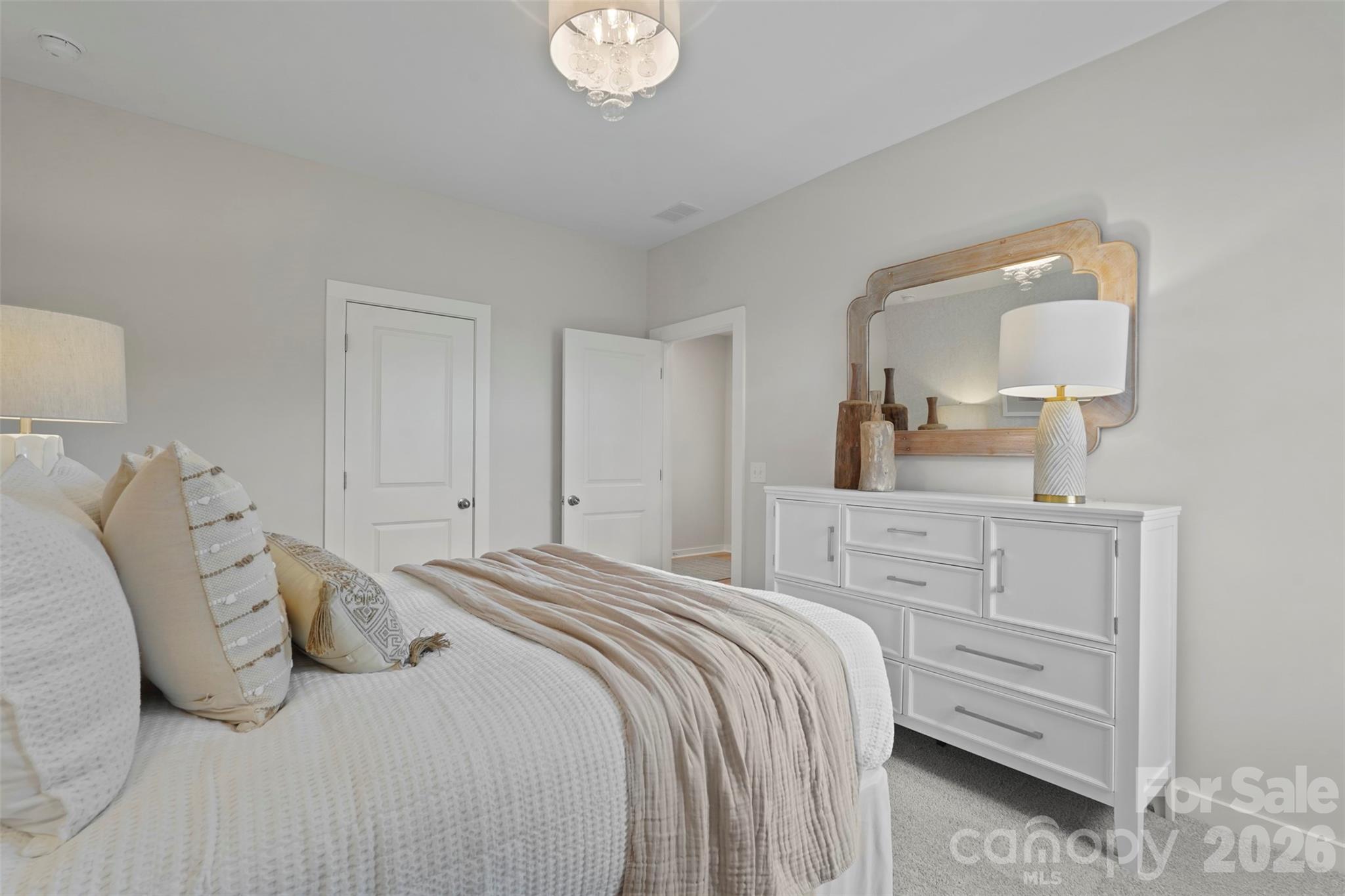 1099 Arundle Road Sherrills Ford, NC 28673 - Photo 16 of 40 a bedroom with a bed and a mirror