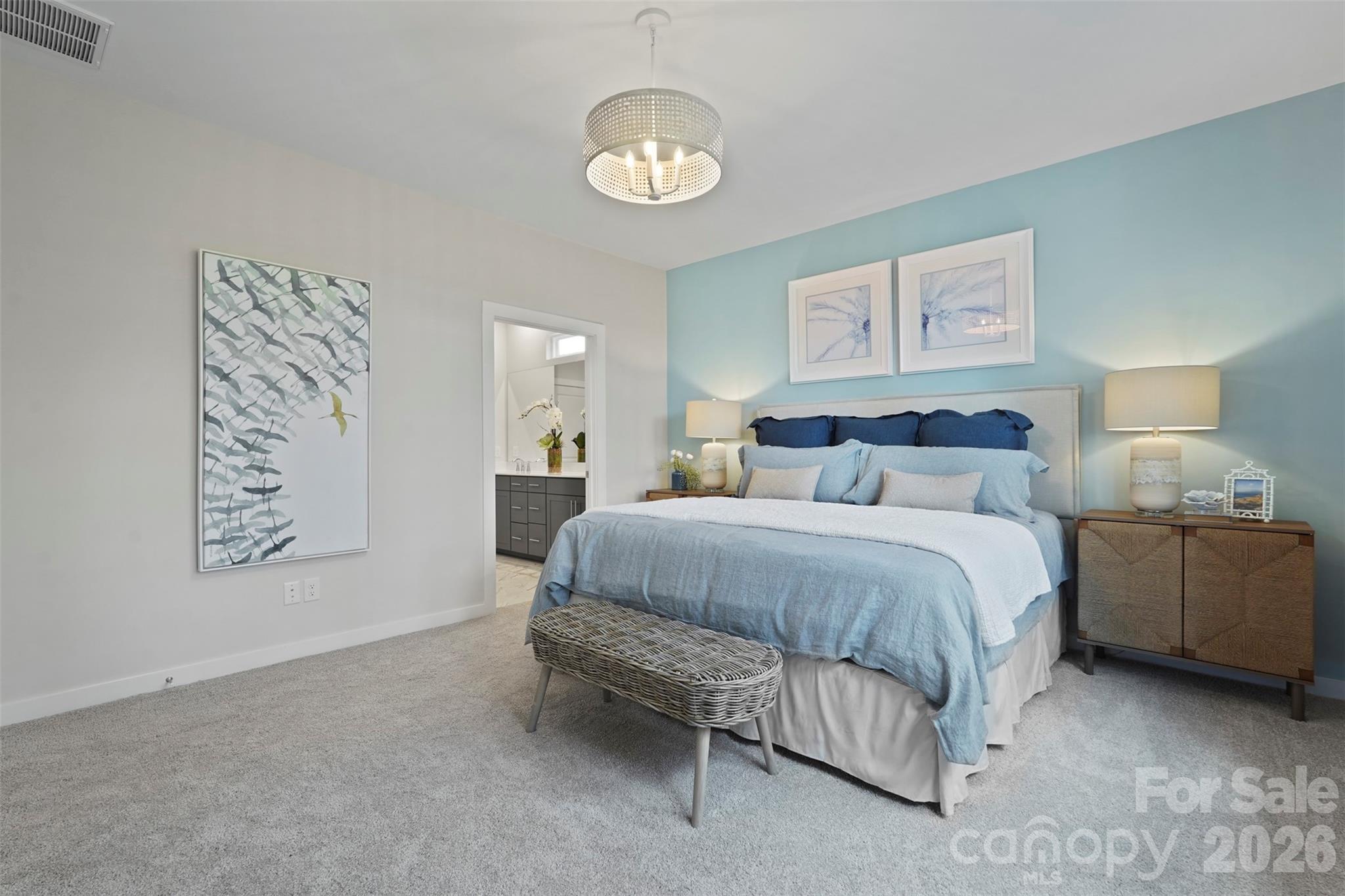 1099 Arundle Road Sherrills Ford, NC 28673 - Photo 3 of 40 a bedroom with a bed and a lamp on dresser