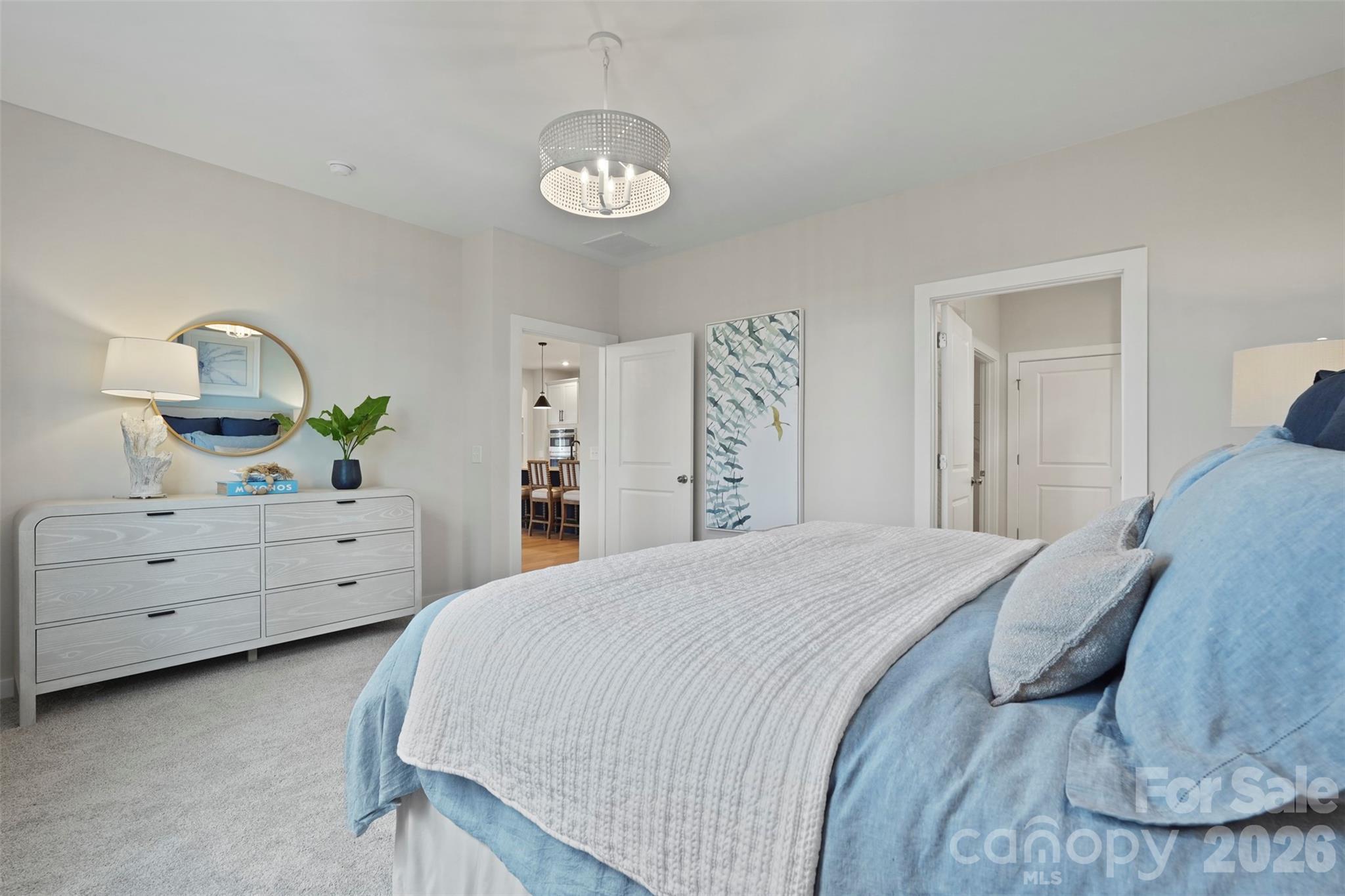 1099 Arundle Road Sherrills Ford, NC 28673 - Photo 5 of 40 a spacious bedroom with a bed and a chandelier