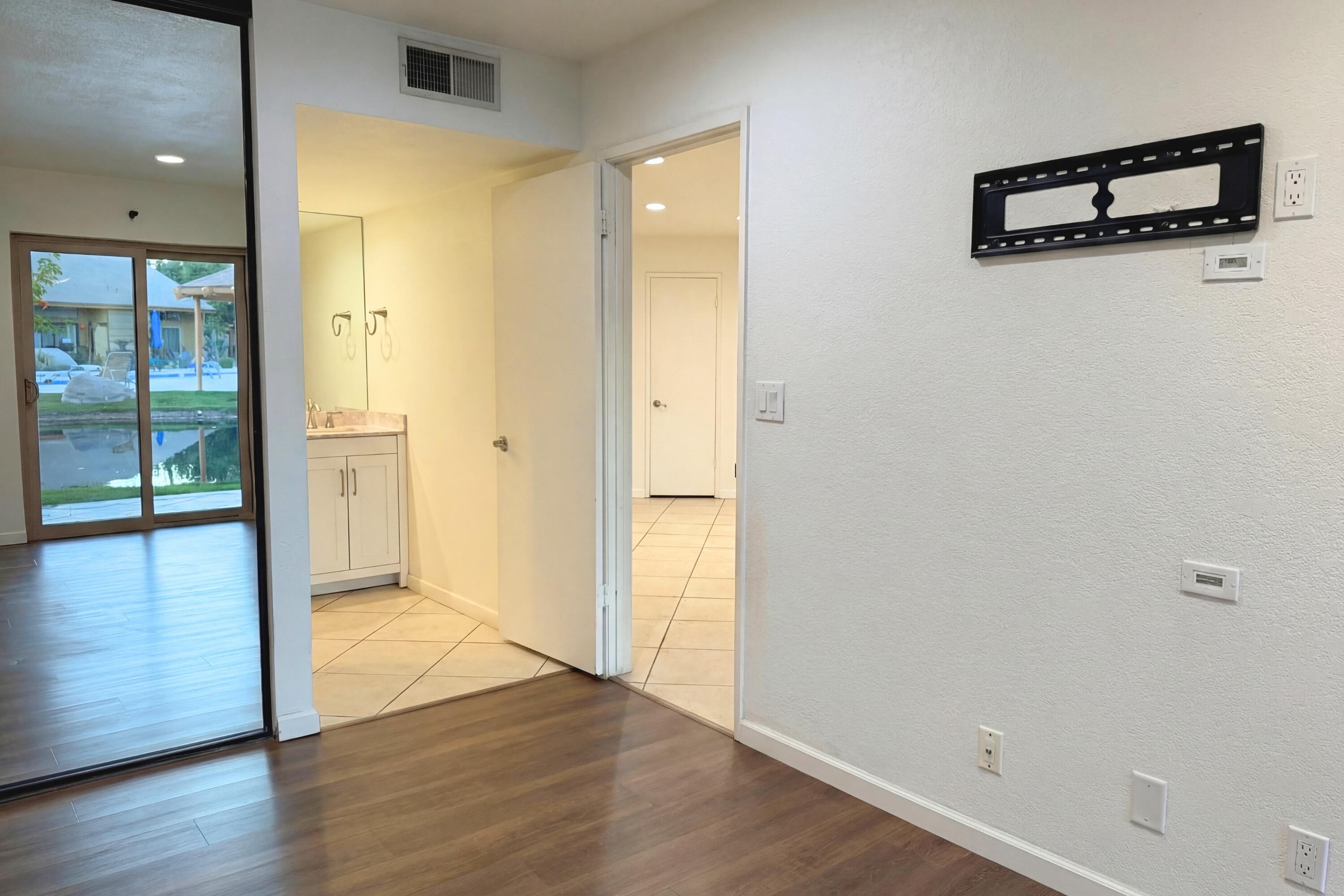 48255 Monroe Street, Unit 20 Indio, CA 92201 - Photo 11 of 21 a view of a hallway with wooden floor