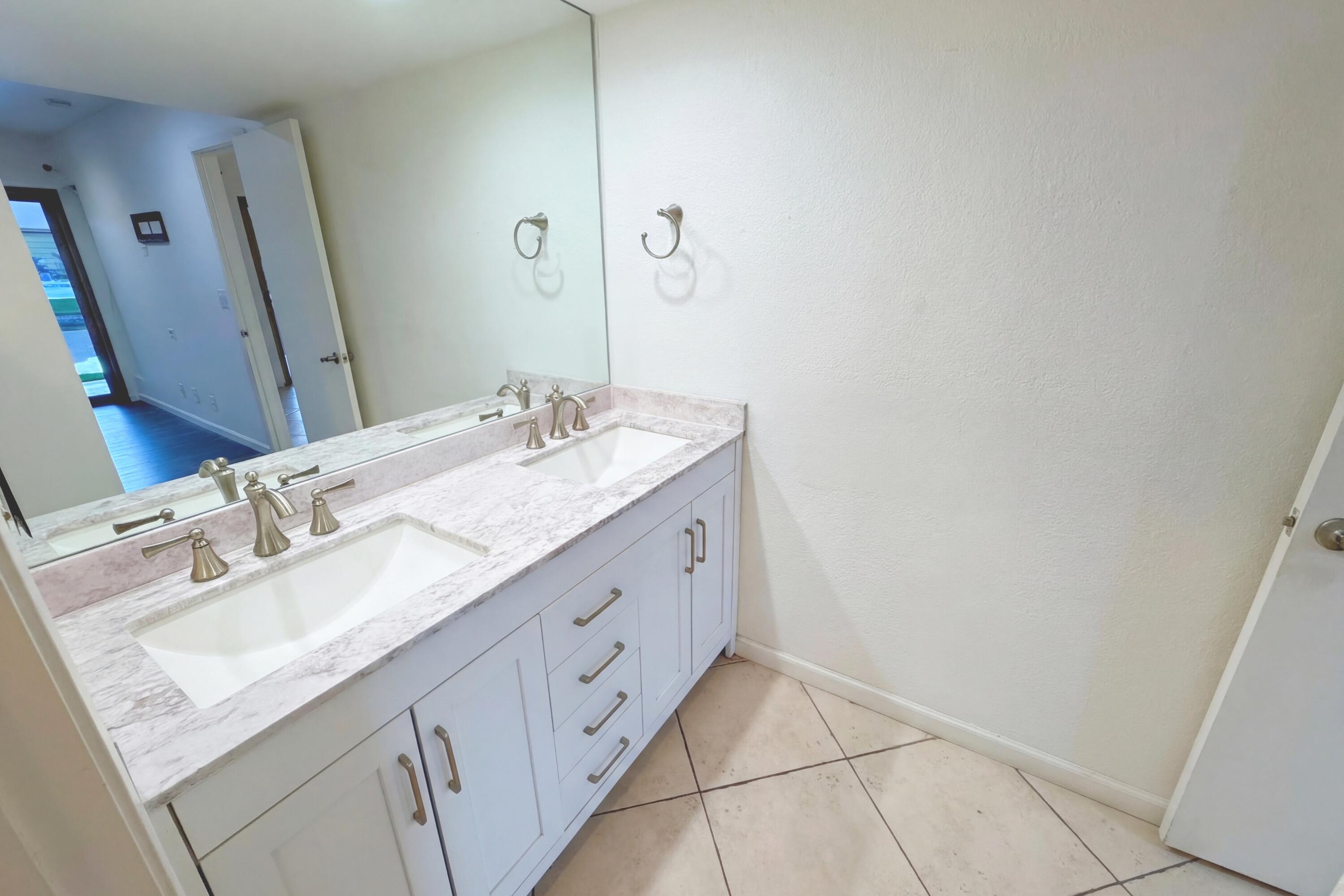 48255 Monroe Street, Unit 20 Indio, CA 92201 - Photo 12 of 21 a bathroom with a double vanity sink and mirror