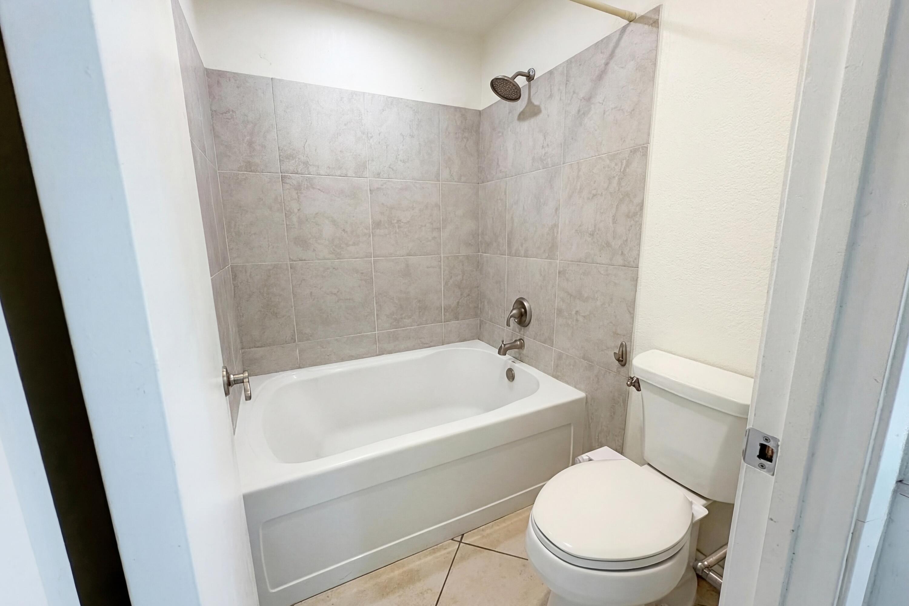 48255 Monroe Street, Unit 20 Indio, CA 92201 - Photo 13 of 21 a white toilet sitting next to a bath tub