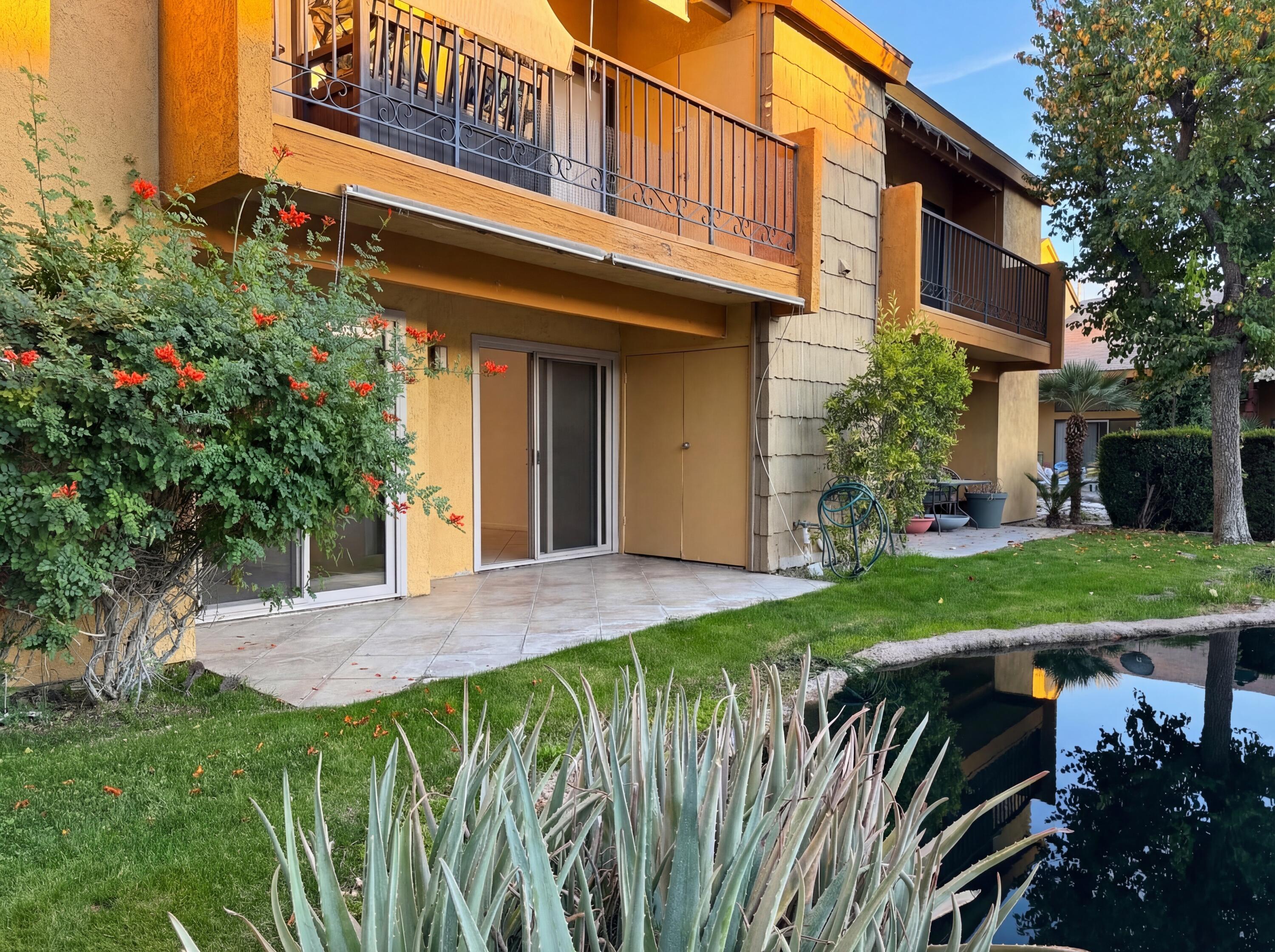48255 Monroe Street, Unit 20 Indio, CA 92201 - Photo 18 of 21 a view of a house with a yard and plants