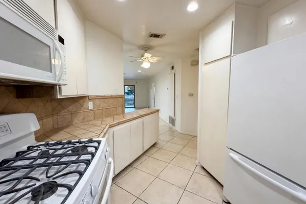 a kitchen with stainless steel appliances a stove a sink and a refrigerator