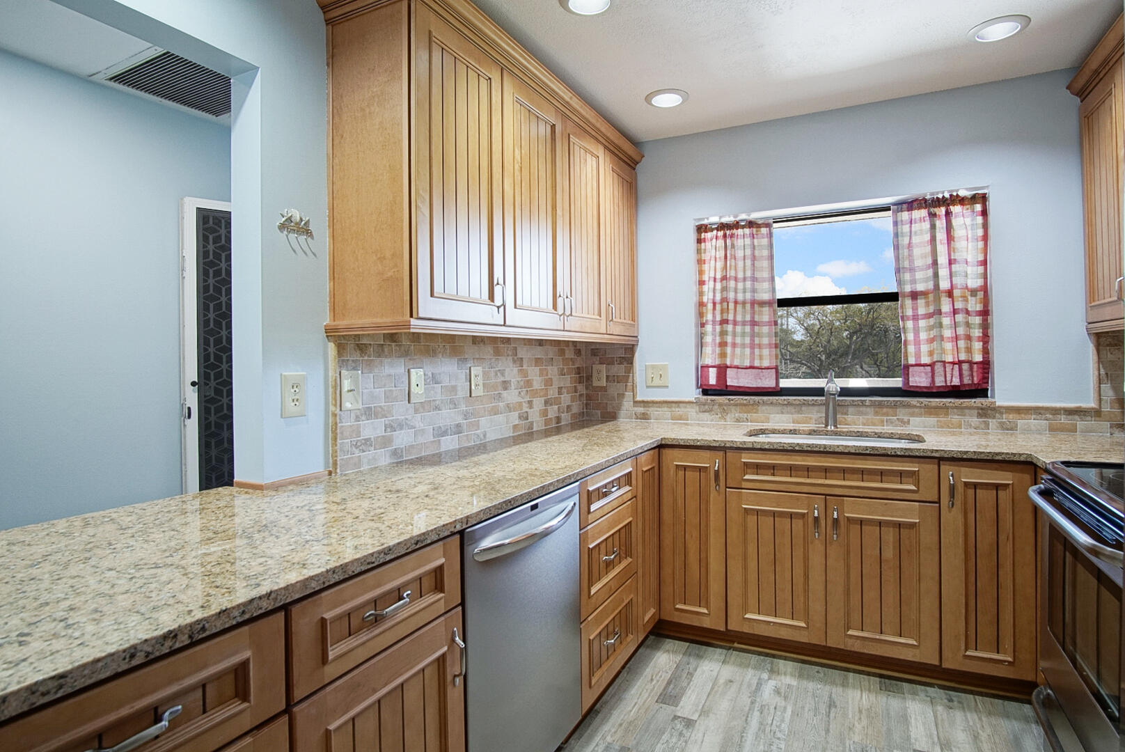 6041 Southeast Landing Way Stuart, FL 34997 - Photo 18 of 30 a kitchen with a sink stove and cabinets