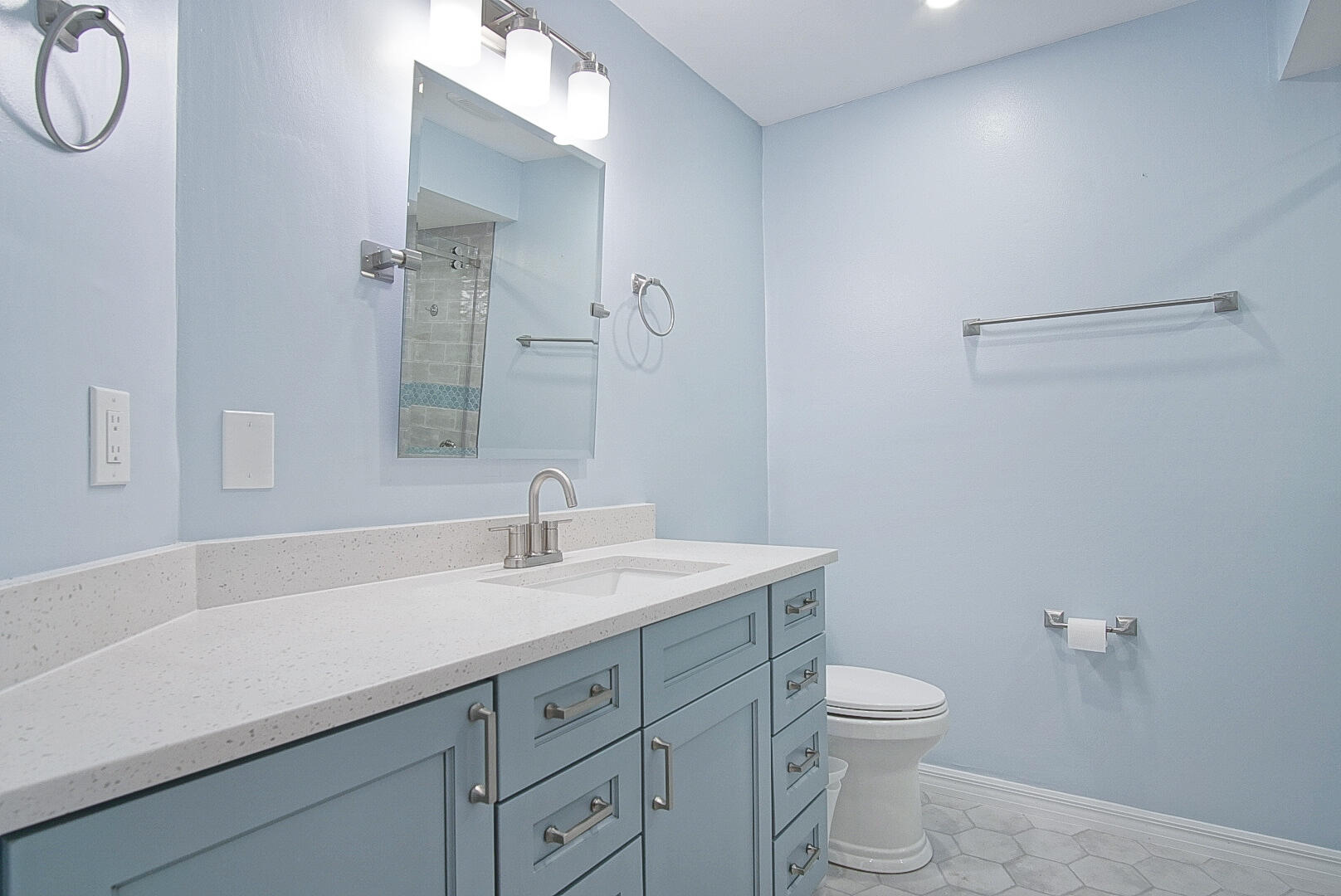 6041 Southeast Landing Way Stuart, FL 34997 - Photo 20 of 30 a bathroom with a granite countertop sink a toilet and a mirror