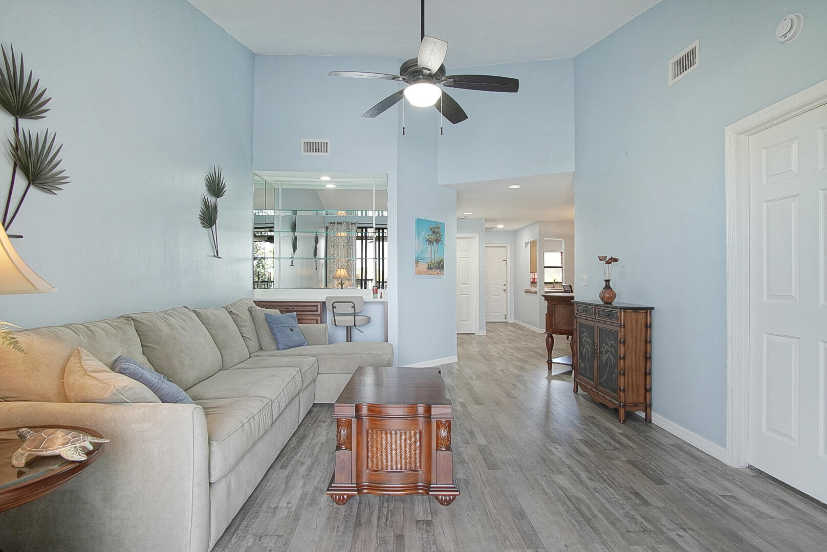 6041 Southeast Landing Way Stuart, FL 34997 - Photo 2 of 30 a living room with furniture and a chandelier