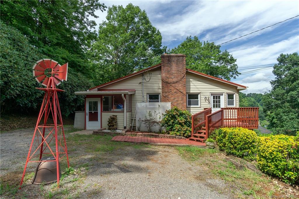 27 New Valley Road Swannanoa, NC 28778 - Photo 2 of 42 a front view of a house with a yard and potted plants