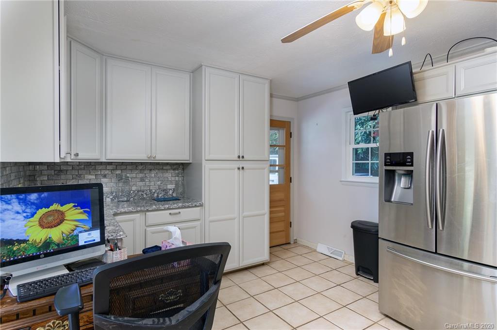 27 New Valley Road Swannanoa, NC 28778 - Photo 12 of 42 a kitchen with stainless steel appliances kitchen island granite countertop a refrigerator and a stove top oven