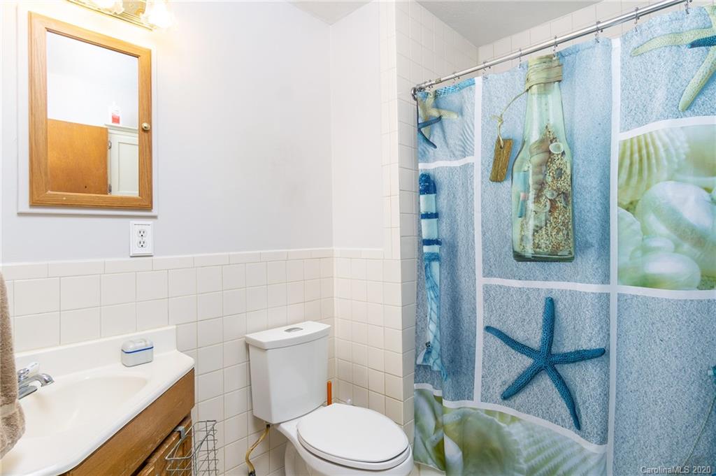 27 New Valley Road Swannanoa, NC 28778 - Photo 14 of 42 a bathroom with a toilet and a sink