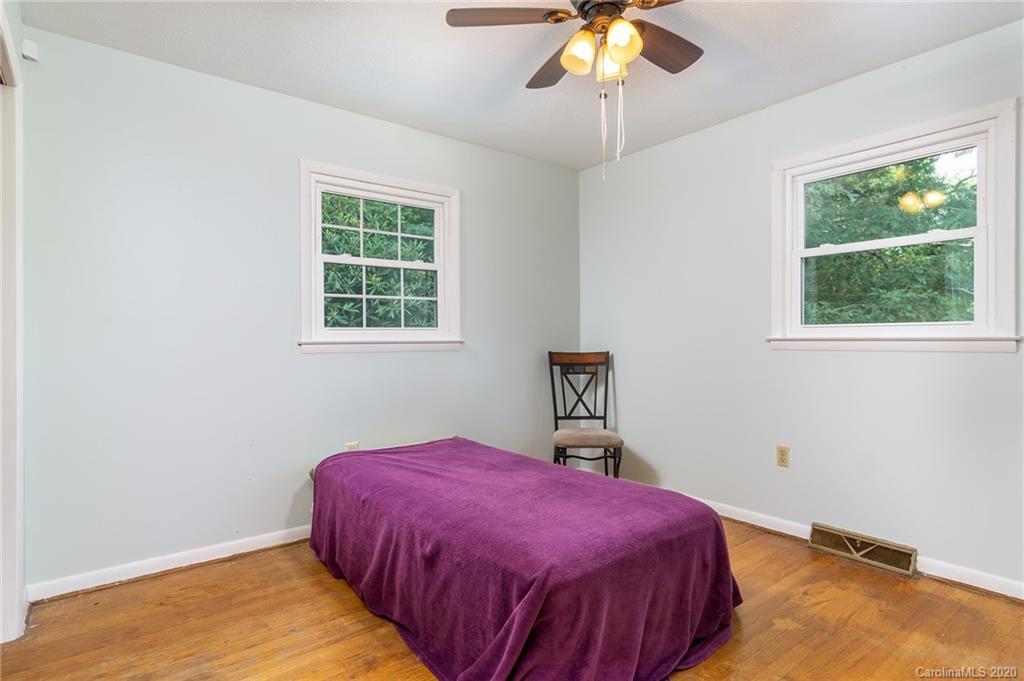 27 New Valley Road Swannanoa, NC 28778 - Photo 15 of 42 a bedroom with a bed and a chandelier