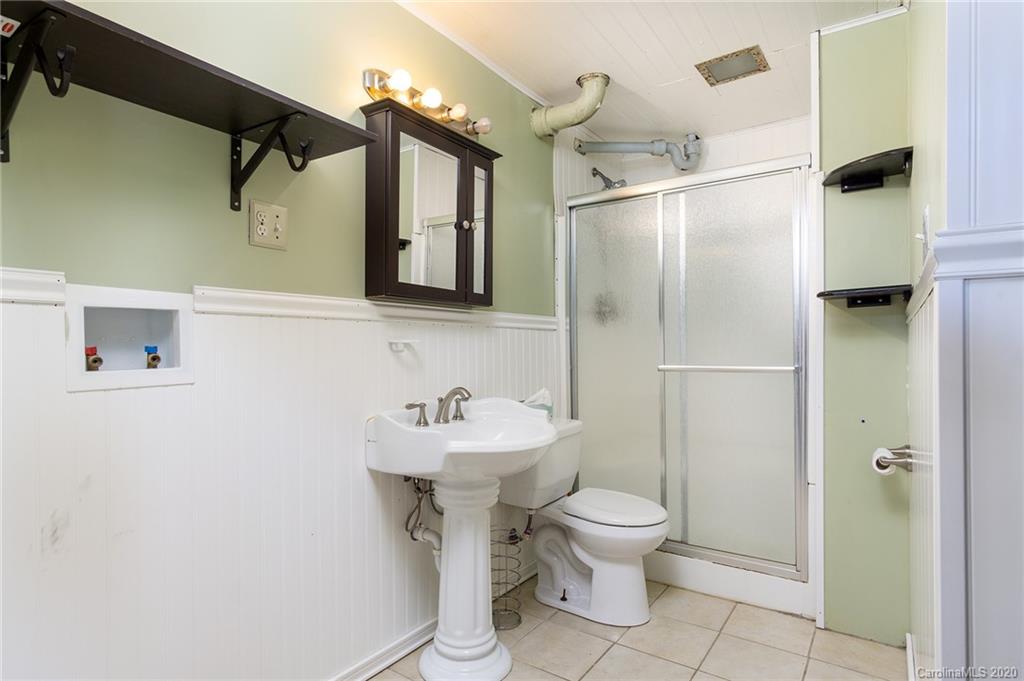 27 New Valley Road Swannanoa, NC 28778 - Photo 23 of 42 a bathroom with a sink toilet and shower