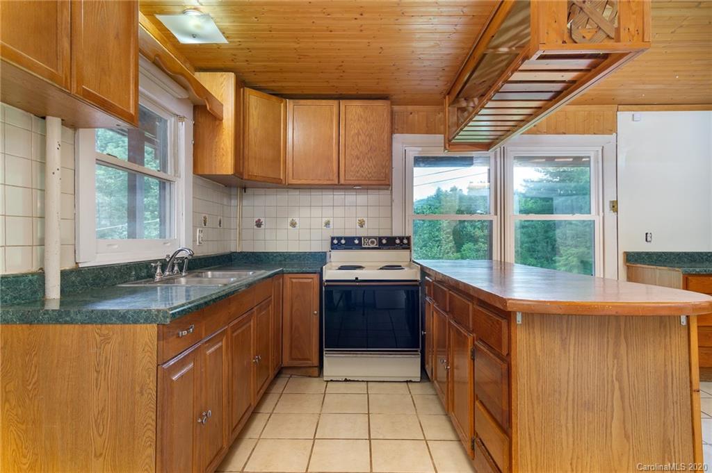27 New Valley Road Swannanoa, NC 28778 - Photo 27 of 42 a kitchen with stainless steel appliances granite countertop a sink and a stove