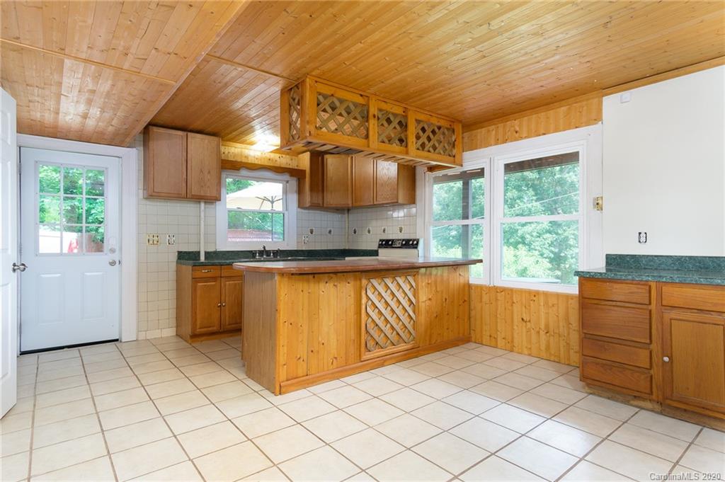 27 New Valley Road Swannanoa, NC 28778 - Photo 28 of 42 a kitchen with stainless steel appliances granite countertop a stove a sink and a refrigerator