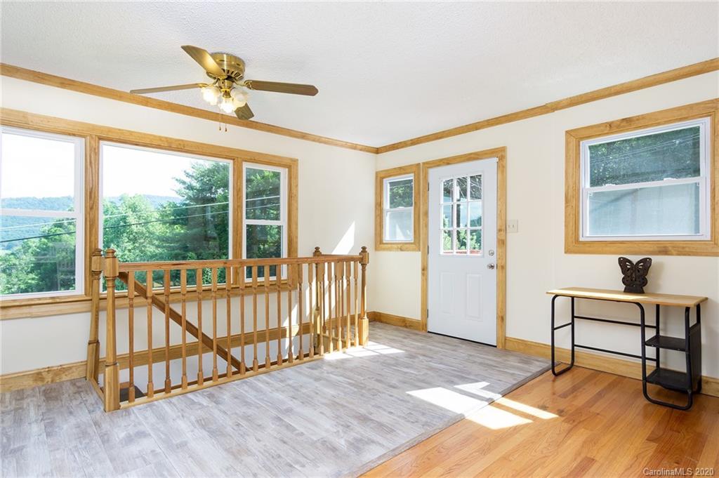 27 New Valley Road Swannanoa, NC 28778 - Photo 4 of 42 a view of a bedroom with furniture window and hardwood floor