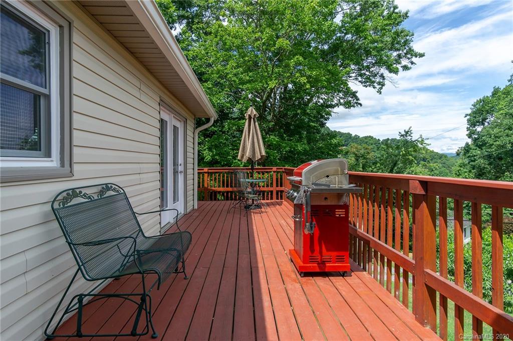 27 New Valley Road Swannanoa, NC 28778 - Photo 31 of 42 a balcony with wooden floor and outdoor seating