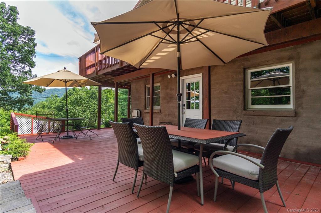 27 New Valley Road Swannanoa, NC 28778 - Photo 39 of 42 a view of a patio with table and chairs under an umbrella