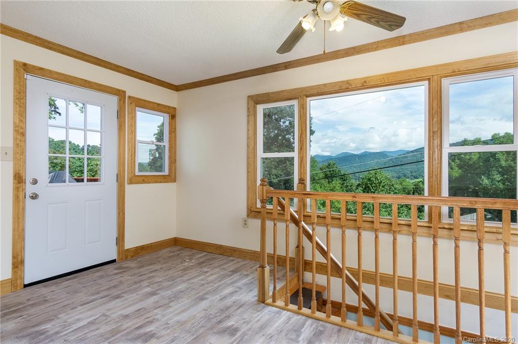 27 New Valley Road Swannanoa, NC 28778 - Photo 5 of 42 a view of a porch with wooden floor and outdoor space