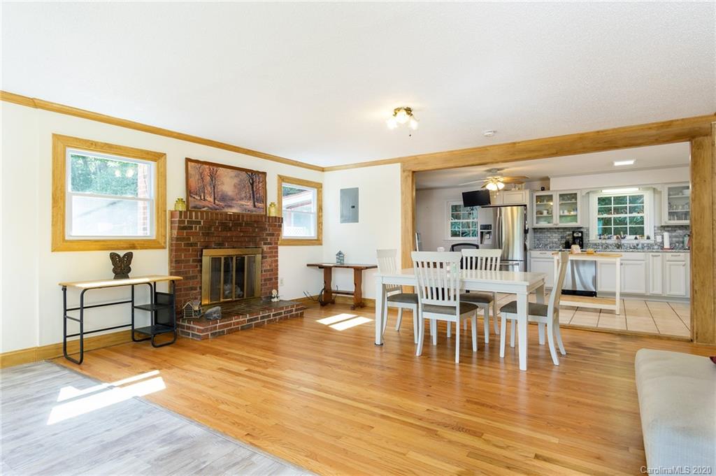 27 New Valley Road Swannanoa, NC 28778 - Photo 6 of 42 a living room with furniture a fireplace and a table