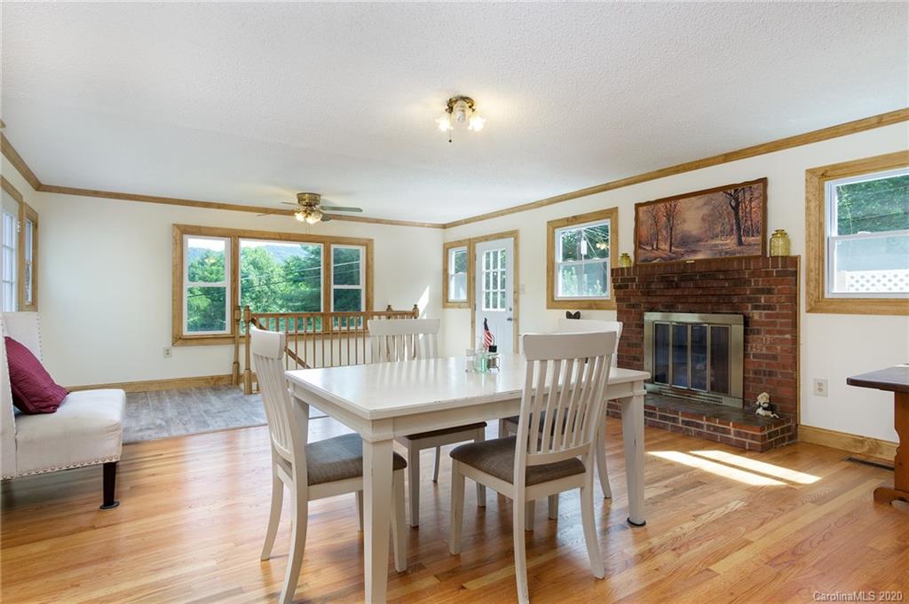 27 New Valley Road Swannanoa, NC 28778 - Photo 8 of 42 a view of a dining room with furniture window and wooden floor