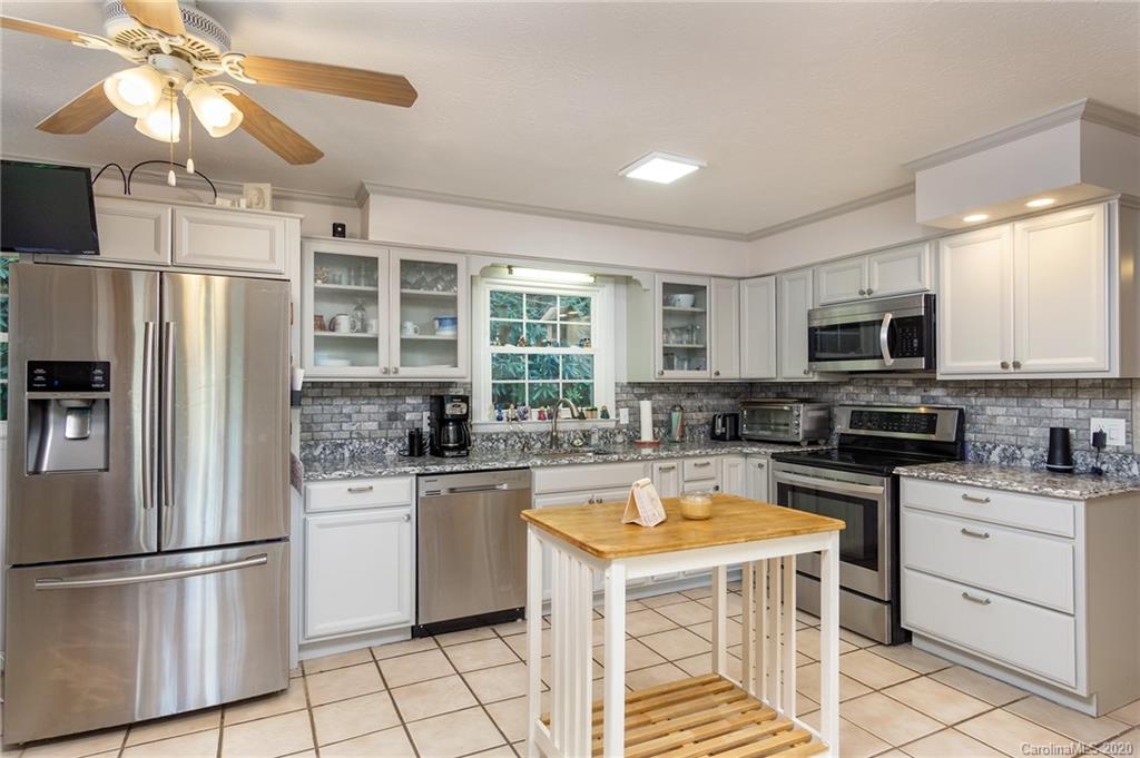 27 New Valley Road Swannanoa, NC 28778 - Photo 9 of 42 a kitchen with a stove a refrigerator and a sink