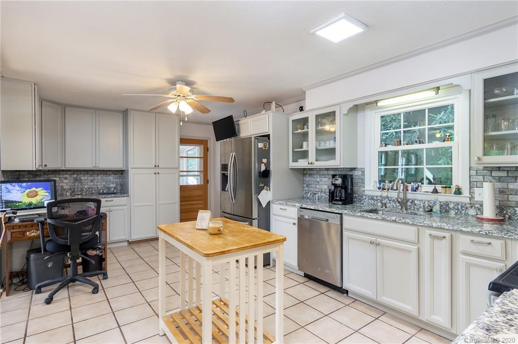 27 New Valley Road Swannanoa, NC 28778 - Photo 10 of 42 a kitchen with a sink a stove a refrigerator and cabinets