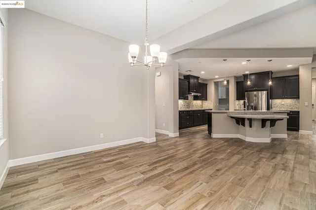a view of a kitchen with a sink stainless steel appliances and cabinets
