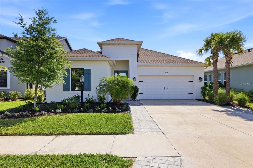 9268 Tequila Sunrise Drive Sarasota, FL 34241 - Photo 2 of 56 a front view of a house with a yard and garage